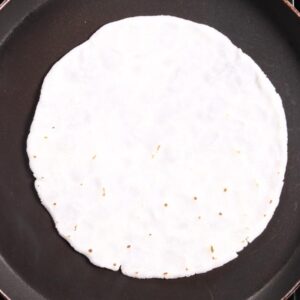 Flipping bhakari on griddle