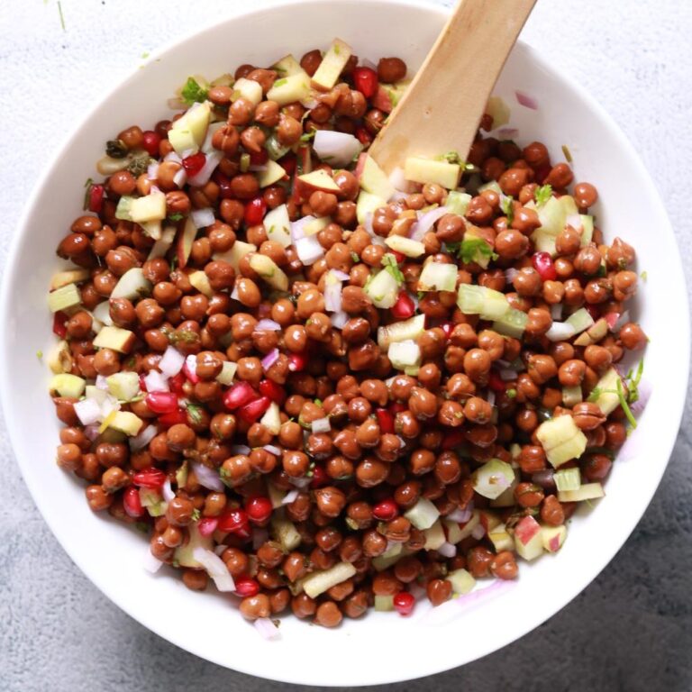 Tossing chana salad ingredients together
